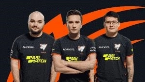 Alexey “Solo” Berezin, Vladimir “No[o]ne-“ Minenko and Bakyt “W_Zayac” Emilzhanov stand in their Virus.pro jerseys against a black and orange background