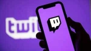 The Twitch logo appears against a purple background on a smartphone screen