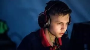 Dmitry “sh1ro” Sokolov concentrates during a live game of CS:GO, his face lit by the light of his monitor