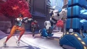 Tracer and McCree follow with guns drawn behind robot T.W.O. in Overwatch 2's Push mode.