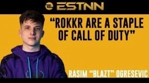 Расим «Blazt» Огрешевич стоит рядом со словами «ROKKR Are A Staple Of Call of Duty» и его именем ниже.  Фон черно-желтый, а сверху находится логотип esportsreview.ru.