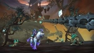 A Night Elf rides her Shimmermist Runner Unicorn through the strange demonic landscape of Shadowlands