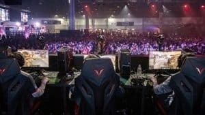 Esports players in gaming chairs infant of a large crowd