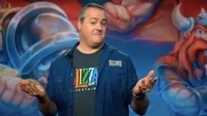 Former Blizzard President J. Allen Brack wears a Blizzard t-shirt and shrugs with a smug look on his face.