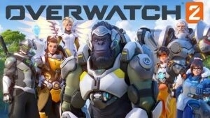 Группа героев Overwatch стоит под солнечным небом вместе с логотипом Overwatch 2 над головой.