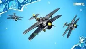 A trio of toy biplanes soar across a blue background